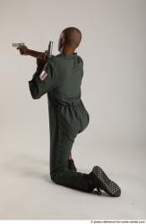 Man Adult Average Black Fighting with gun Kneeling poses Casual